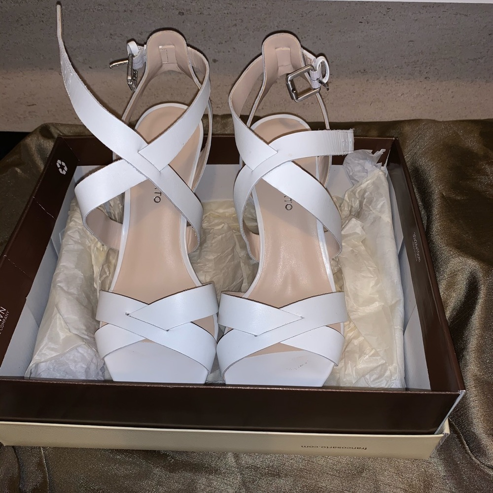 Woman’s white wedge sandals